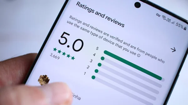 Customer checking a business's star ratings and reviews on a phone, a key Google Maps ranking signal